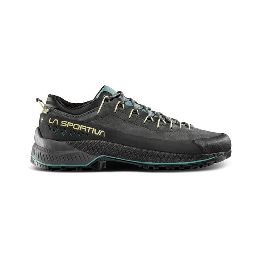 The La Sportiva TX4 EVO Women's is a black and dark green eco-friendly leather shoe with yellow accents, a low-cut design, rugged Vibram Megagrip sole, and laces, shown in a side view against a white background.