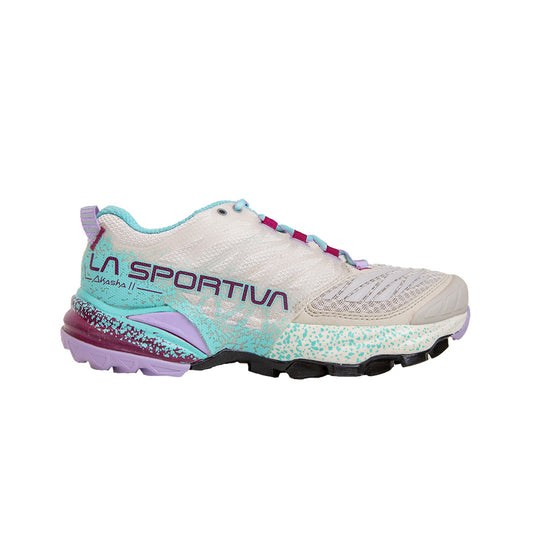 The La Sportiva Akasha II Women's is a beige and light blue trail running shoe with purple and turquoise accents, speckled midsole, and side branding. Its rugged outsole delivers reliable traction for technical terrain and high mileage adventures.