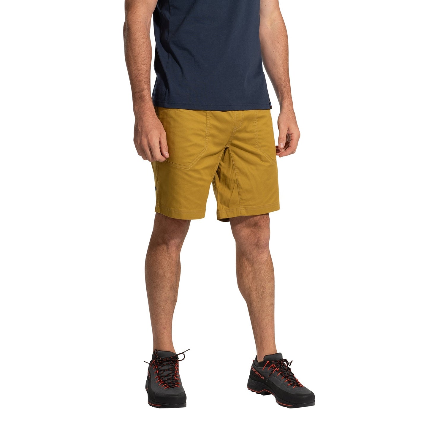 A person stands facing forward with hands relaxed at their sides, wearing La Sportiva Roots Shorts Men's (2025) in mustard yellow. The image is cropped below the shoulders.