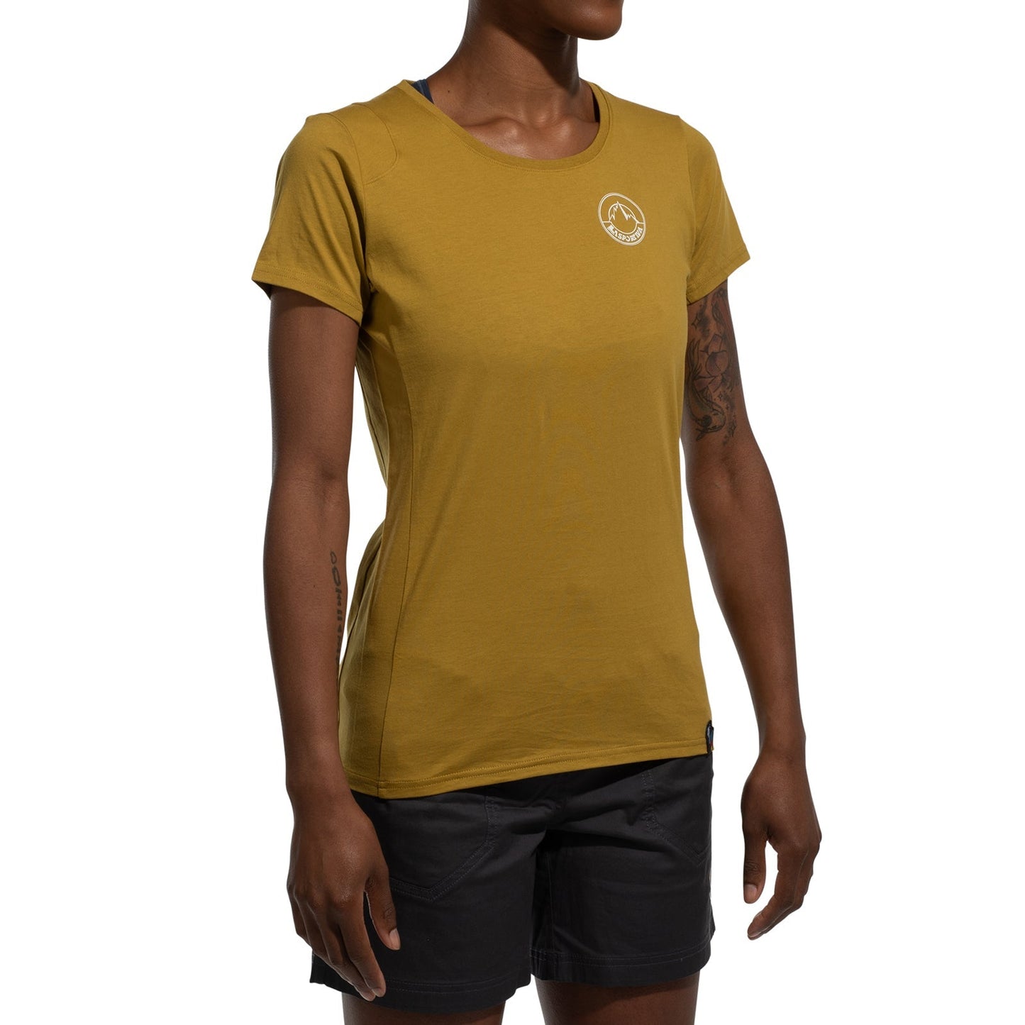 A minimalist climber wears a mustard yellow La Sportiva Circle Logo T-Shirt Women's (2025) with a small white logo on the chest and black shorts, standing against a white background.
