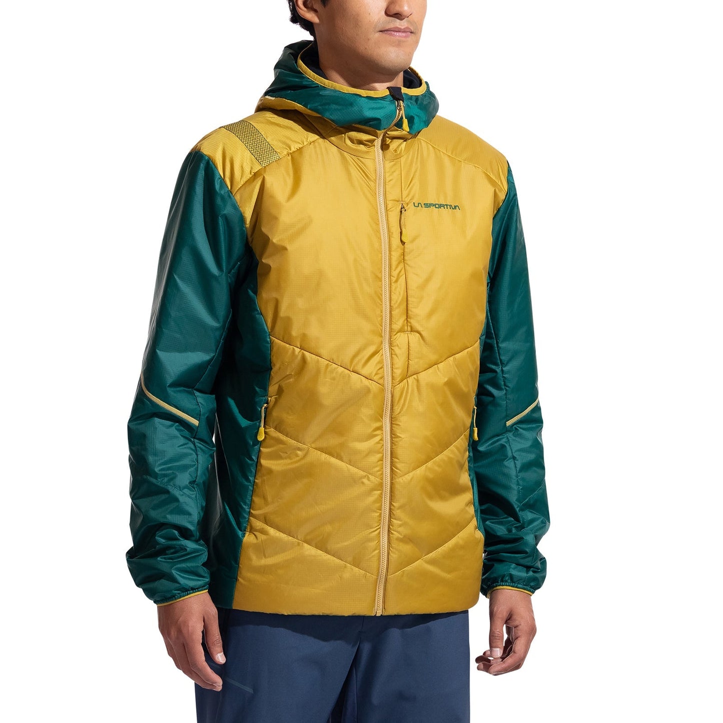 A person in a La Sportiva Mythic Primaloft Jacket Men's, featuring PrimaLoft Silver Eco insulation with a yellow body and green sleeves and shoulders, stands against a plain white background with the zip-front hood resting at their sides.