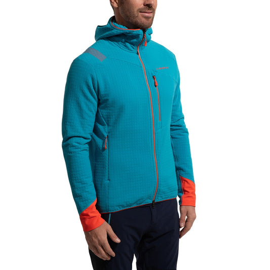 A man wears the La Sportiva Bristen Thermal Hoody Men's in bright blue with orange accents, featuring chest and side pockets, designed for technical mountaineering and outdoor use, standing against a white background.