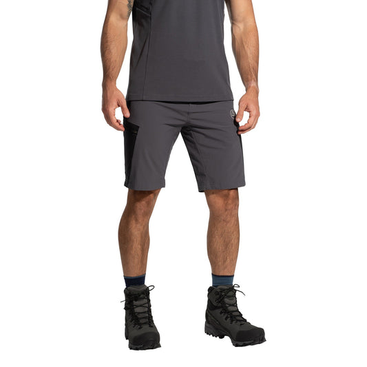 A person wearing a dark gray t-shirt, La Sportiva West Crest Shorts Men's (2025) with pocket details, dark socks, and black hiking boots stands against a white background—perfect for fans of practical outdoor gear.