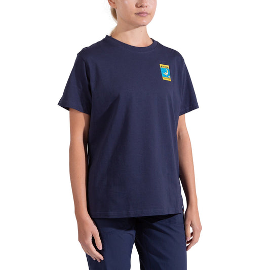 A woman wearing the La Sportiva Moon Climb T-Shirt Women’s in organic cotton with a small colorful patch on the chest and matching navy pants stands against a white background, her face partially out of frame.