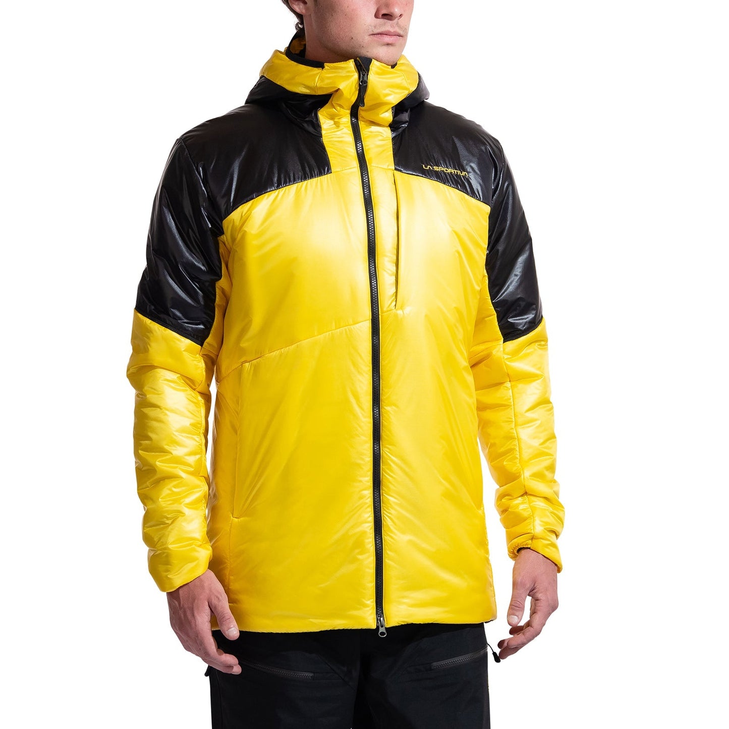 A person wears a bright yellow La Sportiva Supercouloir Primaloft Parka Men's with black accents on the shoulders and upper sleeves, standing against a plain white background. This technical jacket delivers advanced alpine insulation.