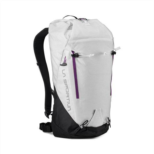 The La Sportiva Granite 22 Backpack is a white and black technical daypack with purple zipper accents, padded shoulder straps, buckles, and a minimalist design. It’s displayed standing upright against a white background.