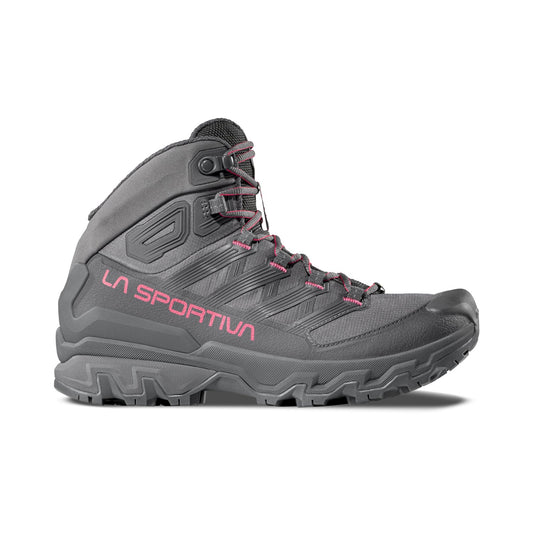 The La Sportiva Ultra Raptor 3 Mid GTX Women's hiking boot is gray with pink accents and "La Sportiva" in pink on the side. It features rugged tread, ankle support, waterproof protection, and is shown in left profile on a white background.