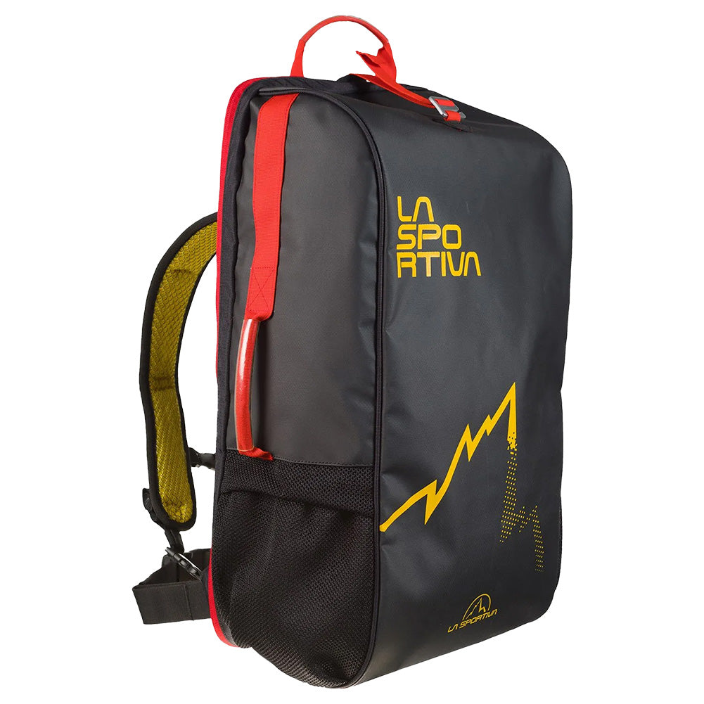 The La Sportiva Travel Bag is a black backpack with a yellow logo, mountain graphic, red accents, top handle, mesh side pocket, and padded yellow-backed shoulder straps—ideal for travel or as flight hand luggage.