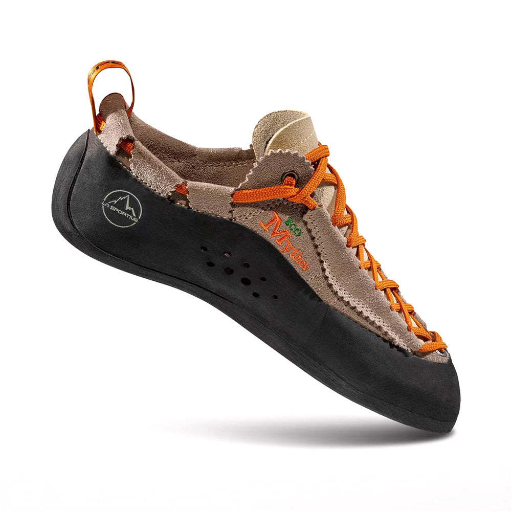 A tan and brown La Sportiva Mythos ECO climbing shoe with orange laces and a black rubber sole, shown on a white background. The side displays logos, ventilation holes, and highlights its eco-friendly construction.