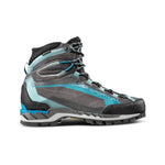 The La Sportiva Trango Tech GTX Women's is a gray and blue high-top mountaineering boot with black laces, a rugged sole, reinforced toe, and semi-automatic crampon compatibility—designed for technical mountain terrain. Shown in side profile on white.