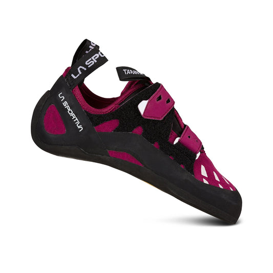 A single La Sportiva Tarantula Women's climbing shoe in maroon and black with Velcro straps, a rubber sole, and branded on the heel strap and side is displayed on a white background.