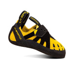 The La Sportiva Tarantula Jr is a yellow and black entry-level climbing shoe with a Velcro strap, rubber sole, and neutral shape for comfort. The side-facing design displays the La Sportiva and Tarantula Jr names.