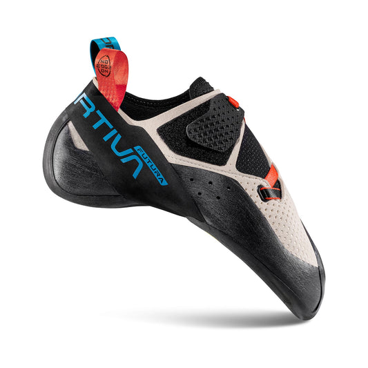 A single La Sportiva Futura climbing shoe in beige, black, and red is shown from the side, featuring a velcro strap, textured rubber sole, and a blue heel pull tab with visible branding on the side.
