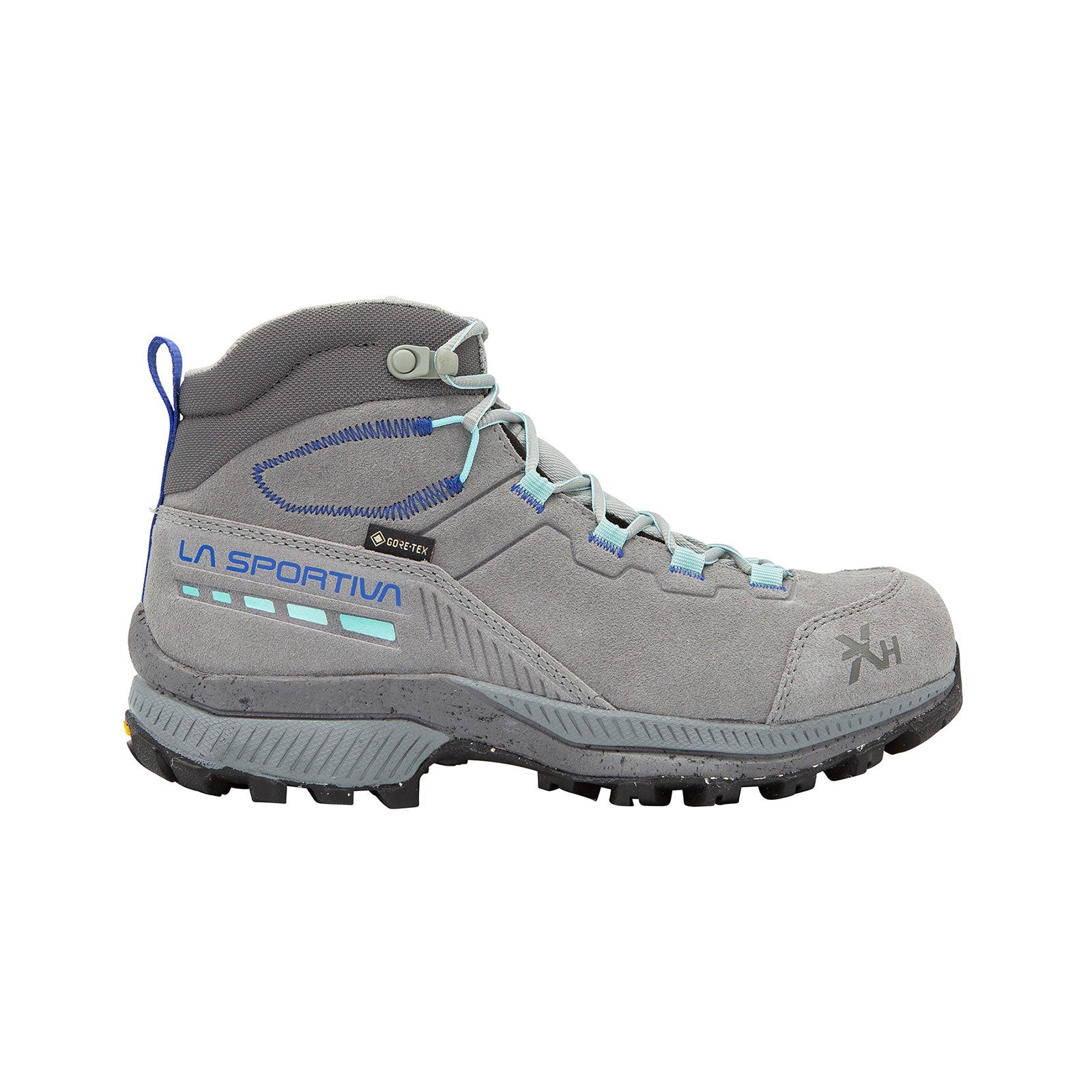 The La Sportiva TX Hike Mid Leather GTX Women's shoe is gray with light blue accents, black tread, metal eyelets, and features a reinforced toe and heel for durability. “La Sportiva” branding appears on the side.