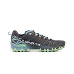 The La Sportiva Bushido II GTX Women's trail running shoe features black and teal colors with green accents, a rugged traction sole, mesh upper, and geometric side patterns, shown in side profile on a white background.