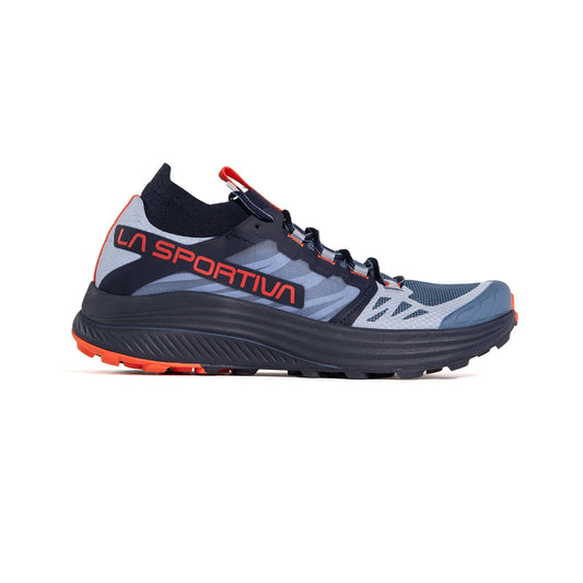 The Levante Women's by La Sportiva is a blue and gray long-distance running shoe with black laces, black sole, orange tread, bold orange LA SPORTIVA branding, designed for stability and optimal cushioning on trails.