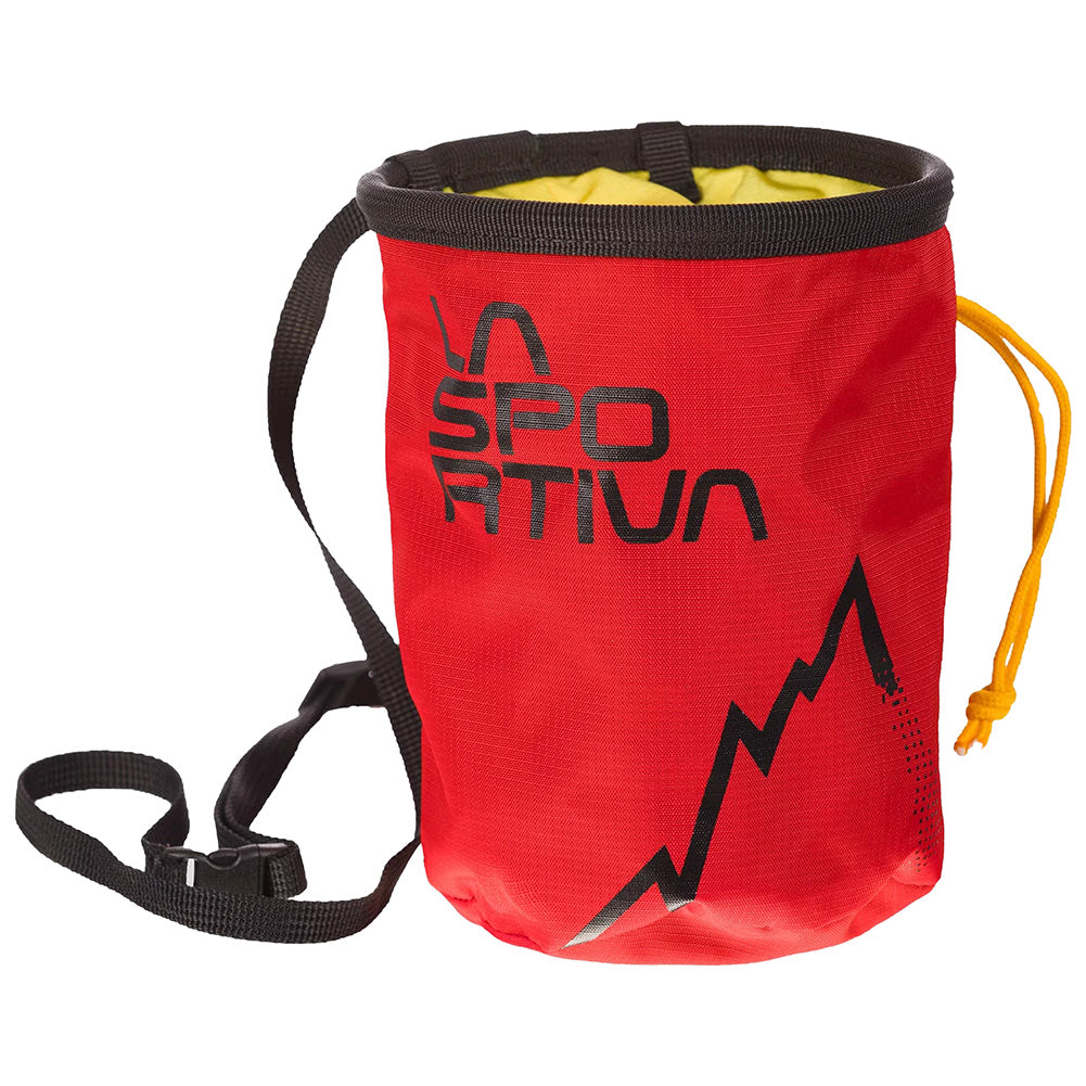 The La Sportiva LSP Chalk Bag is red with a black strap, drawstring closure, and features a black mountain graphic on the front. It stands upright and has a yellow lining inside.