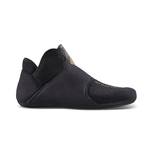 The Stratos VI Liner by La Sportiva is a black, soft-soled shoe with a flexible, low-profile design, slight heel, hook-and-loop closure, and textured fabric—crafted for comfort and movement like a lightweight race boot.