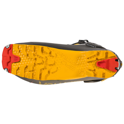 Sole view of the La Sportiva Skorpius CR: a yellow and black trail shoe with deep, aggressive treads plus red rubber on heel and toe for traction—ideal grip inspired by skimo racing footwear.