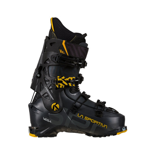 The La Sportiva Vega is a black and yellow ski boot with three adjustable buckles, a high ankle cuff, and rugged sole, designed for alpine skiing or mountaineering with excellent downhill performance.