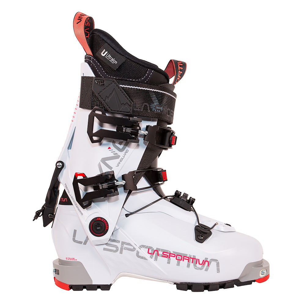 The La Sportiva Vanguard Women's ski boot features a white design with black buckles, red and black accents, a ski/walk mode lever, high cuff, and rugged sole—ideal for backcountry or powder skiing adventures.
