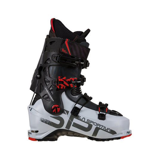 A La Sportiva Vega Women's backcountry boot in white, black, and red is shown in profile, featuring several adjustable buckles and a durable design for ski mountaineering or alpine touring with strong downhill performance.