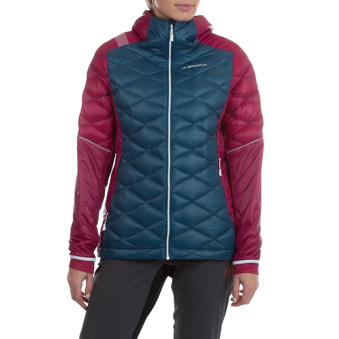 A woman in the La Sportiva Aiguille Down Jacket—a teal and maroon hooded puffer with recycled down, quilted pattern, and logo on the chest—stands against a white background.