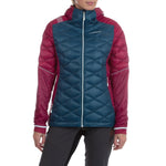 A woman in the La Sportiva Aiguille Down Jacket—a teal and maroon hooded puffer with recycled down, quilted pattern, and logo on the chest—stands against a white background.