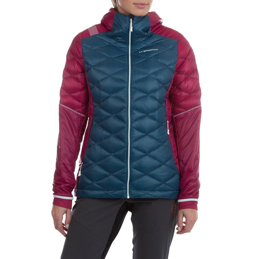 A woman in the La Sportiva Aiguille Down Jacket—a teal and maroon hooded puffer with recycled down, quilted pattern, and logo on the chest—stands against a white background.