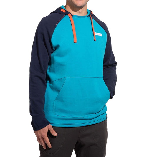 A person wears the La Sportiva Telendos Hoody Men's (2025)—a blue hoody with dark sleeves, orange drawstrings, and a front pocket—paired with dark pants. The individual’s head is not shown in the image.