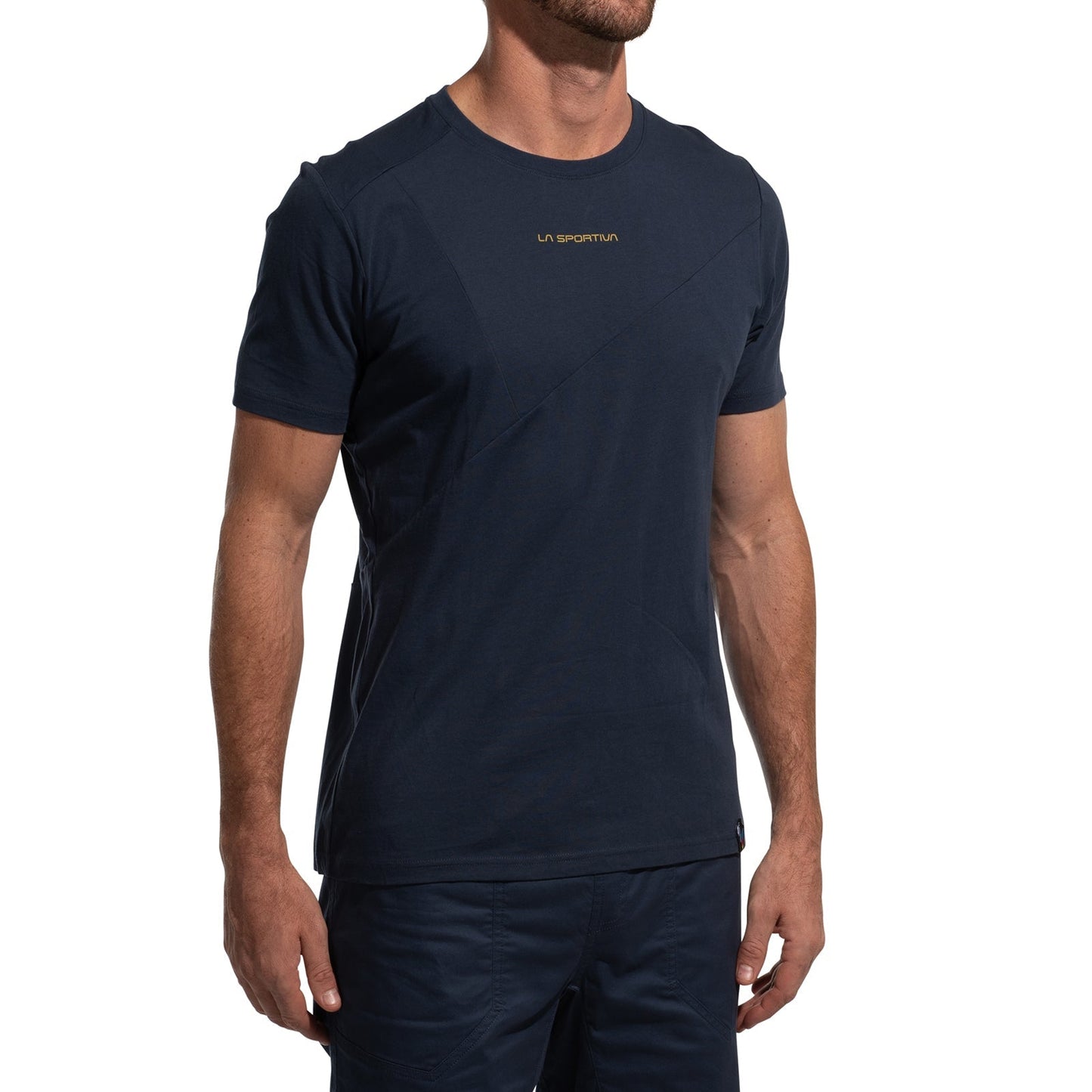 A man wears a navy blue, short-sleeve La Sportiva Dude T-Shirt Men's (2025) with matching shorts. The shirt has small yellow LA SPORTIVA text on the chest. His head is not visible in the image.