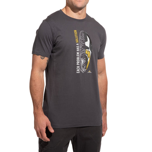 A man wears the La Sportiva Solution T-Shirt Men's (2025), made of organic cotton, featuring a helmet graphic and "EACH PROBLEM HAS A SOLUTION" in white and yellow—ideal for climbers—against a white background.