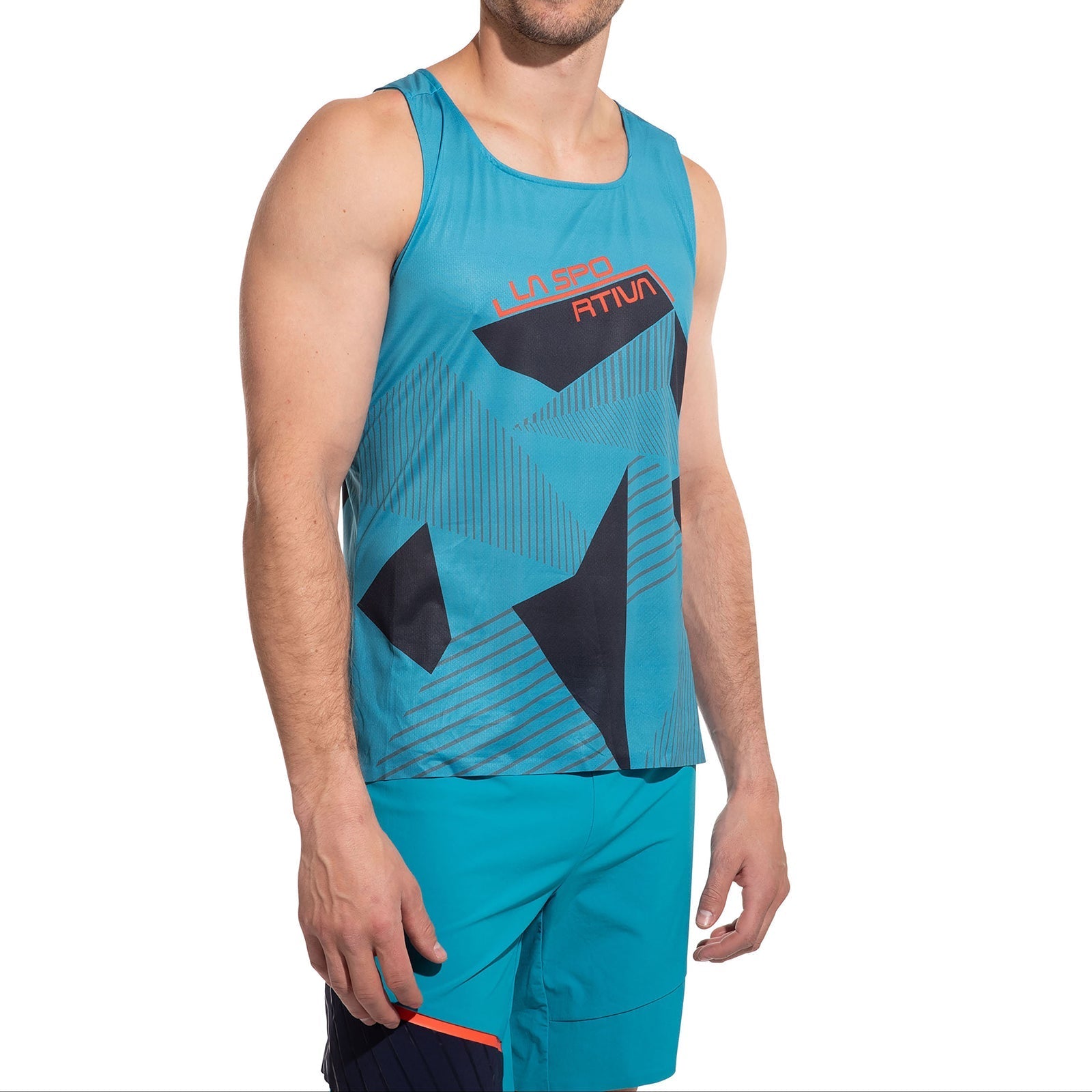 A man wears the La Sportiva Comp Tank Men's—teal, quick-dry, sleeveless with geometric patterns and "La Spo" and "Atium" on the chest—plus matching lightweight teal shorts, standing against a white background.