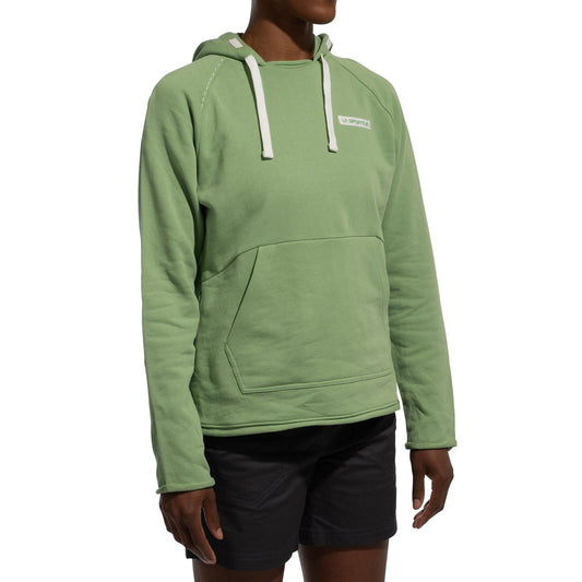 A person wears the La Sportiva Telendos Hoody Women's (2025) in light green with white drawstrings and a front pocket, paired with black shorts, standing against a white background—ideal for outdoor climbing adventures.