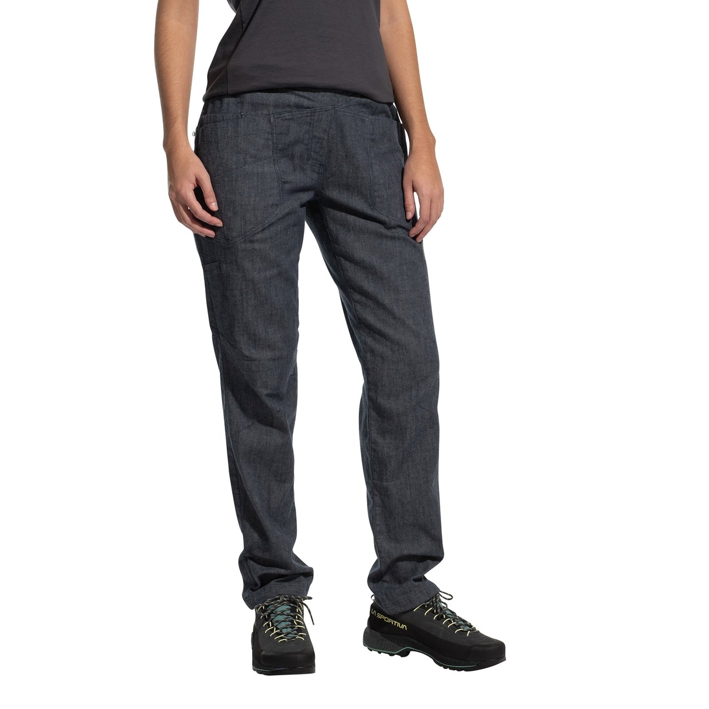 A person models La Sportiva Sierra Rock Pants Women's in dark gray, paired with a dark t-shirt and black hiking shoes with light blue laces, standing against a plain white background. Only the lower body is visible; head and upper torso are not shown.