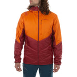A man wears the La Sportiva Mythic Primaloft Jacket, an orange and red two-tone hooded style with PrimaLoft Silver Eco insulation, front zip closure, and two zippered pockets. He stands facing slightly left with arms relaxed at his sides.