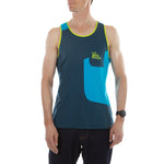 A man wears the La Sportiva Dude Tank M (2023), a loose-fitting, sleeveless teal, blue, and yellow top with a chest pocket and logo, standing with hands by his sides against a plain white background.