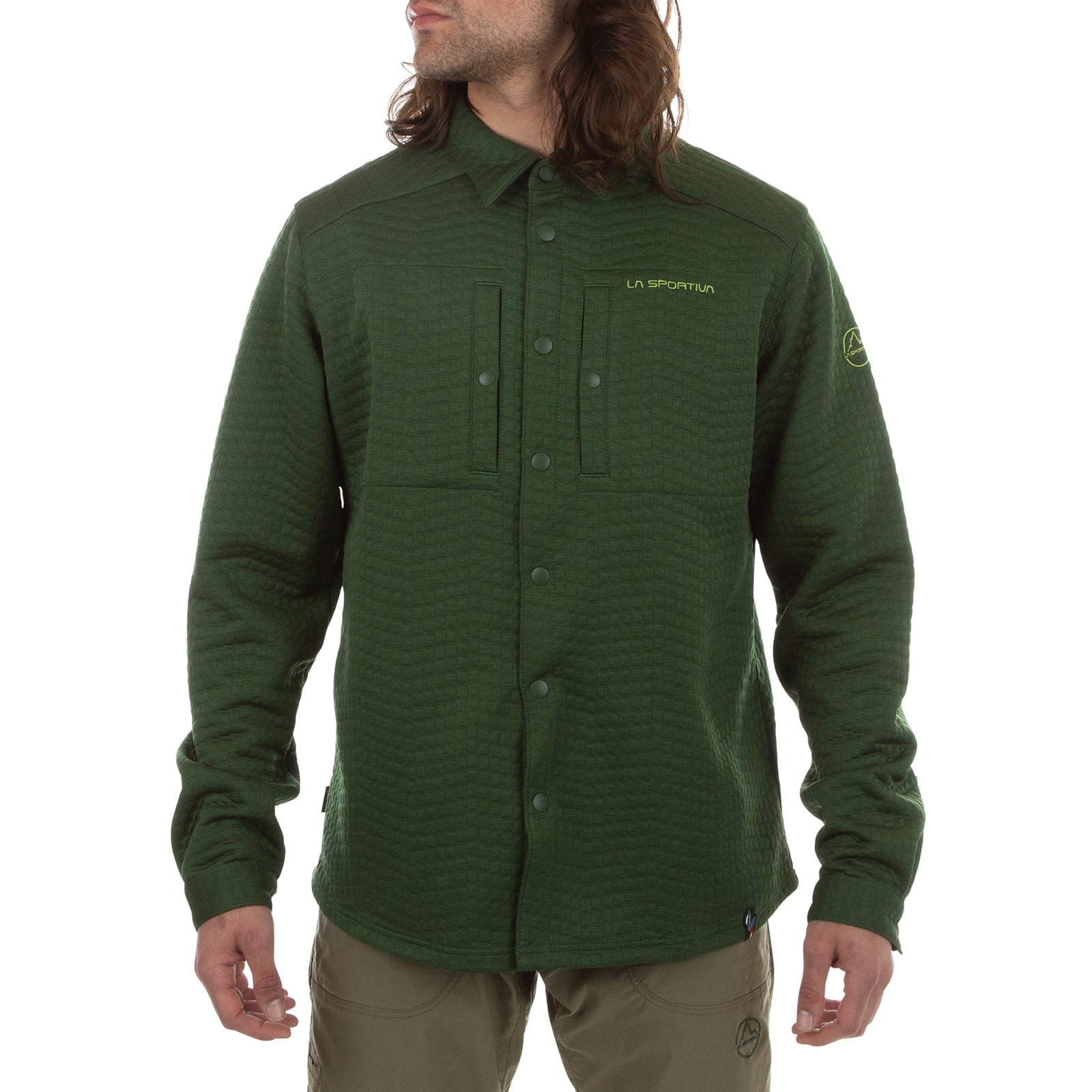 A person wears the La Sportiva Spacer Shirt Men's in olive green, a long-sleeve top made with recycled materials and featuring the La Sportiva logo on the chest and sleeve, standing with arms relaxed and head slightly turned.