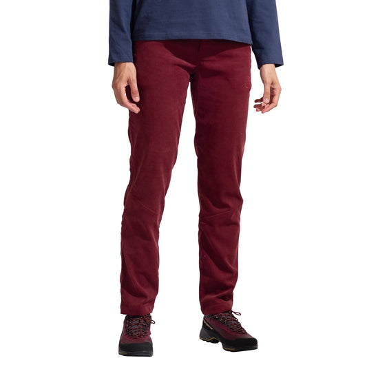 A person stands facing forward against a white background, wearing La Sportiva Setter Pants Women's in burgundy corduroy, a blue long-sleeve shirt, and black hiking boots. The photo is cropped at the shoulders.
