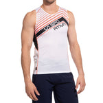 A man models the La Sportiva Slipstream Tank Men's—with orange/black accents and LA SPORTIVA text—paired with navy shorts, against a white background. Its breathable mesh design makes it ideal for competition use.