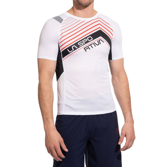 A man stands against a white background in the La Sportiva Wave T-Shirt Men's— a breathable, white running shirt with red and black diagonal stripes and "LA SPORTIVA" on the chest—paired with dark athletic shorts.
