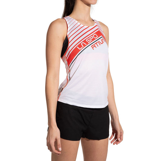 A woman in a La Sportiva Slipstream Tank Women's, featuring a sleeveless white and red design, paired with black shorts, stands against a plain white background.