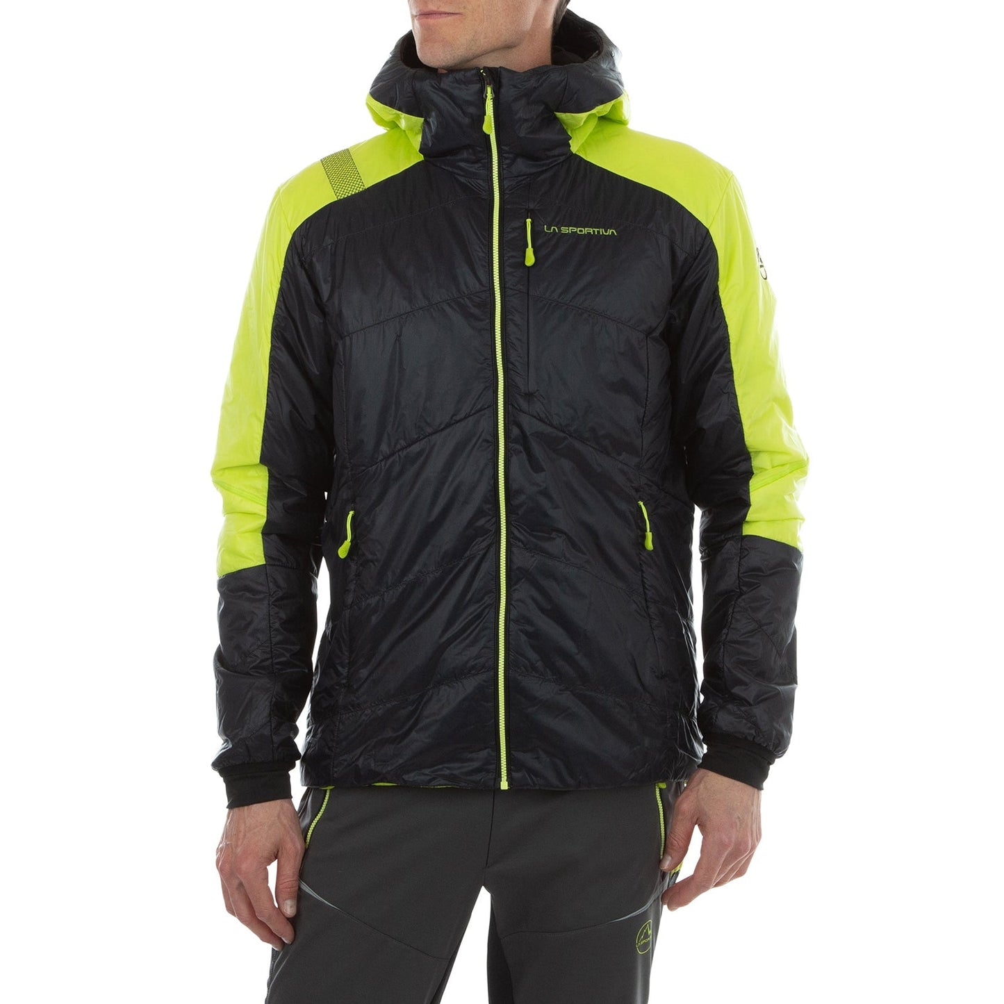 A person wearing a black and neon yellow La Sportiva Alpine Guide Primaloft Hoody Men's (2024) with matching jogger pants stands with arms relaxed at their sides against a white background.