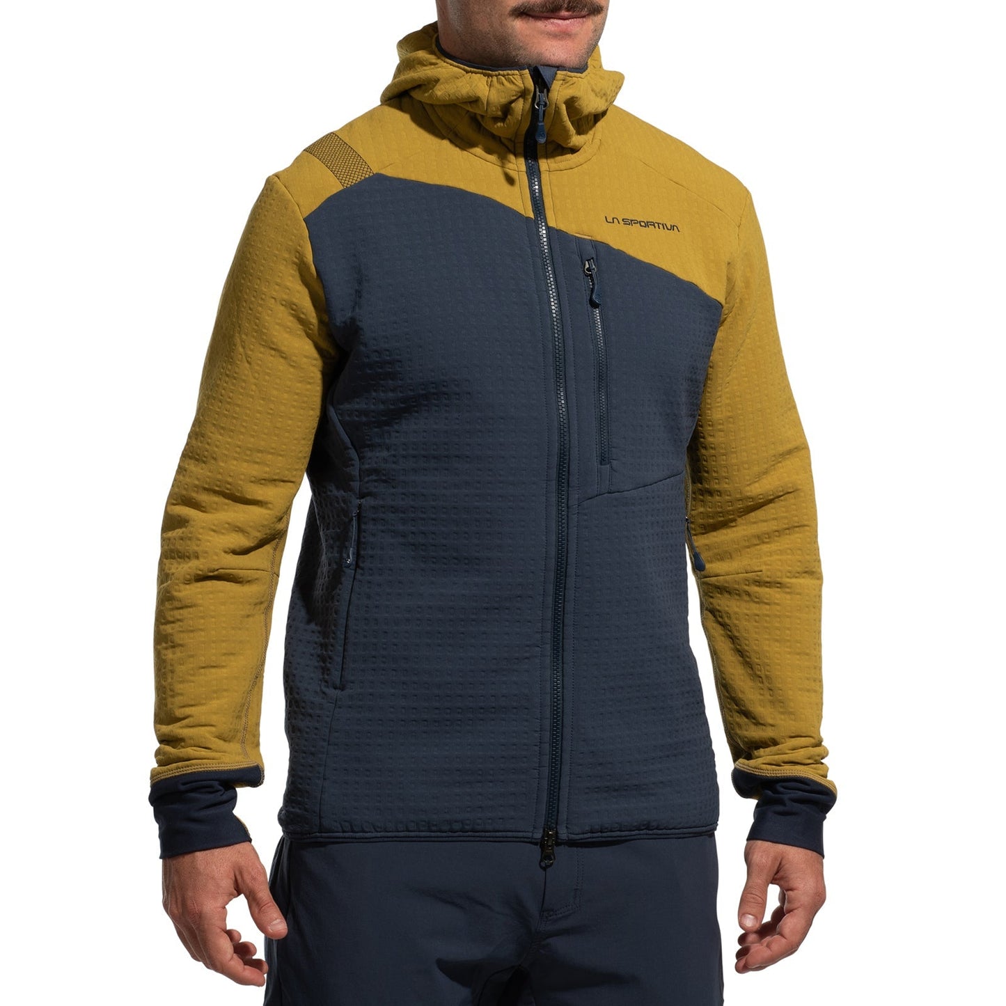 A person wears the La Sportiva Bristen Thermal Hoody Men's—a two-tone jacket with mustard yellow shoulders and hood, dark blue body and sleeves, zippered pockets, and logo—ideal thermal fleece for technical mountaineering.