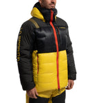 A person wears the La Sportiva Olympus Tech Down Parka Men's, a lightweight, puffy black and yellow jacket with red accents, hood, front zipper, and LA SPORTIVA sleeve logo—ideal for high-altitude mountaineering.