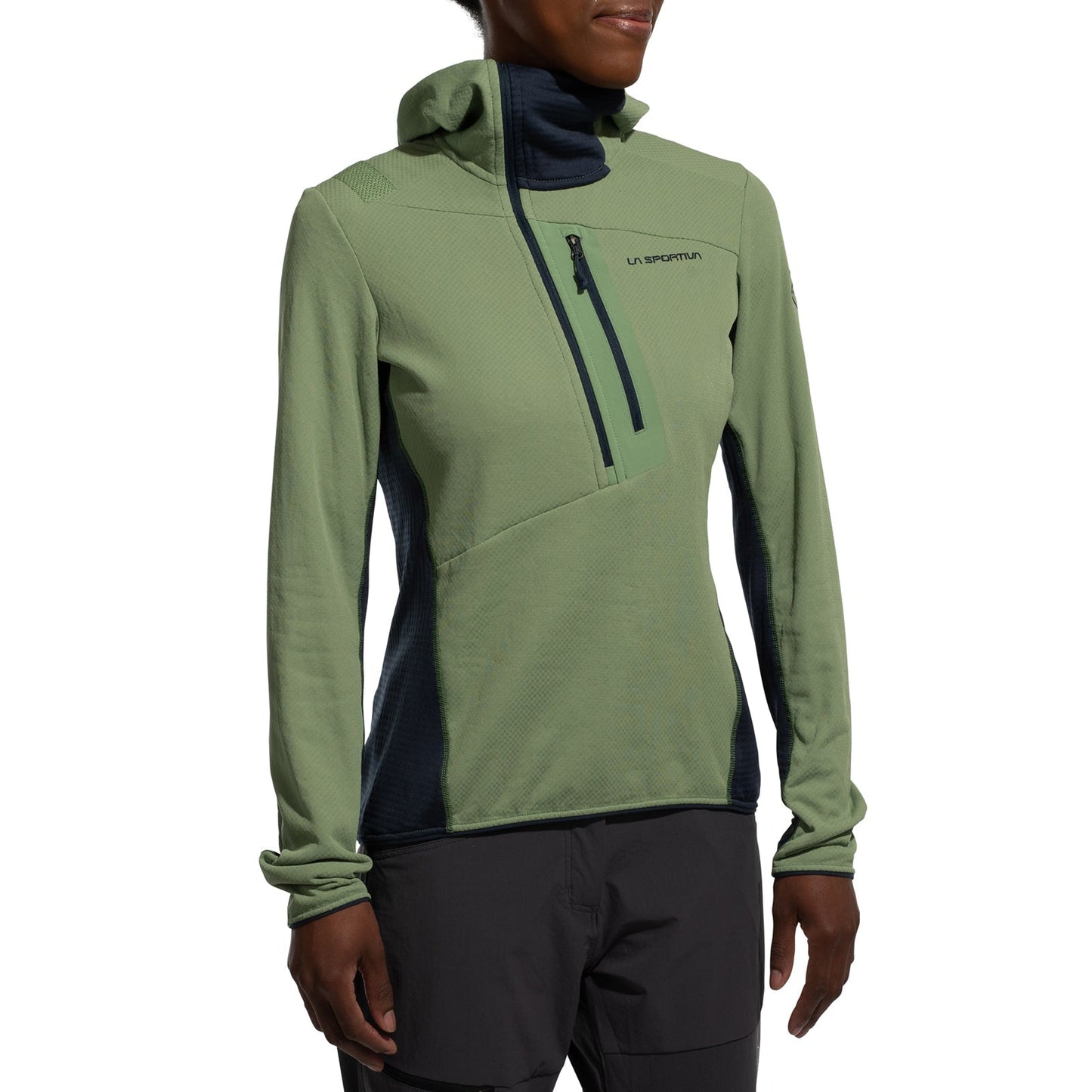 A person wears the La Sportiva Big Wall Pullover Hoody Women's (2025) in light green and dark gray, made with TechStretch Aero Fabric, featuring a chest zipper pocket and La Sportiva branding on the chest.