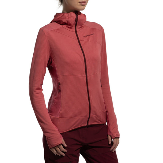 A person wears the La Sportiva Aequilibrium Thermal Hoody Women's (2025), a red Polartec Power Grid zip-up with subtle grid texture and sleeve thumbholes, paired with matching pants, standing against a white background. Face is partially out of frame.