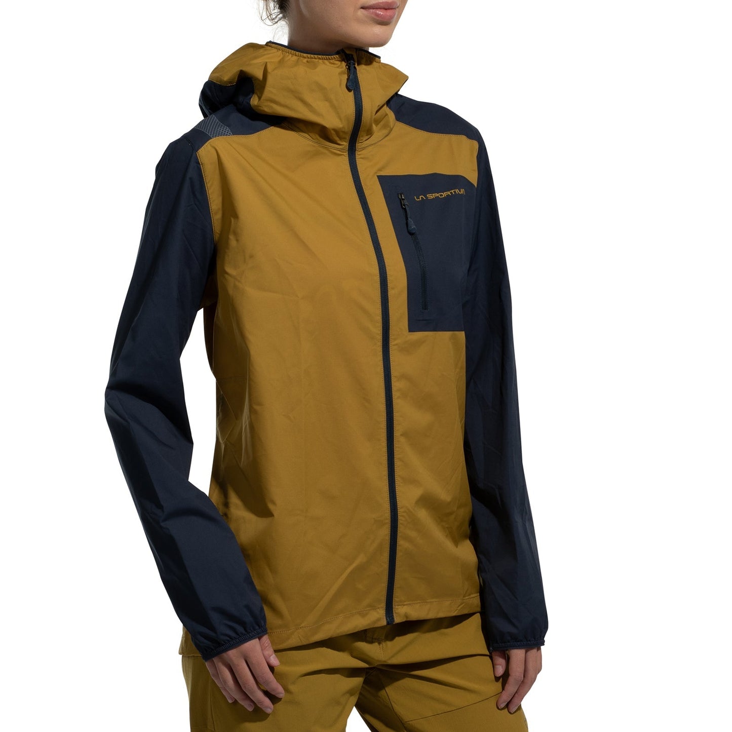 A woman wears the La Sportiva Wall Breeze Stretch Jacket in yellow and navy, featuring a helmet-compatible hood, front zipper, and chest pocket, standing against a white background.