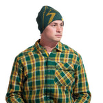A man wearing a green and yellow plaid button-up shirt and the La Sportiva Woolly Beanie with a yellow lightning bolt, looking to the side against a white background—ideal for cold weather and comfort.