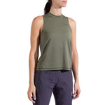 A woman models the La Sportiva Just Right Tank Women's in olive green with dark blue pants, standing against a plain white background. Her face is partly out of frame and her hair is in a ponytail.